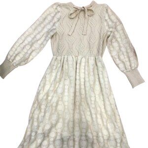 Long knitted dress with a bow neckline and patterned